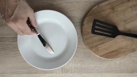 Place fork and knife over plate Stock Footage 121826800