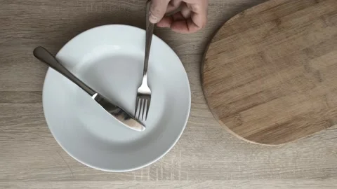 Place fork and knife over plate Stock Footage 121826808