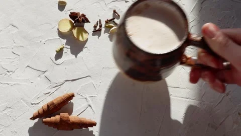 Place a mug of perfect Masala Chai, enhanced with cardamom, star anise Stock Footage 274635306