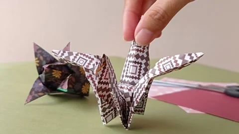Place the origami on a green table Stock Footage 150666430