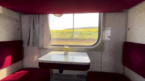 Place for passengers on the train. Table with a cup of tea. The train is moving. Stock Footage 247255005