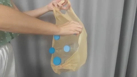 Place plastic bottles in garbage bags and recycle them. waste management Stock Footage 252789473