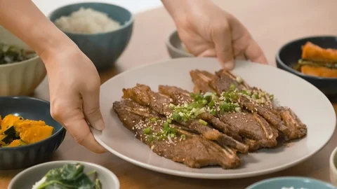 Place the ribs on the table. There are other Korean foods on the table. Stock Footage 115628130