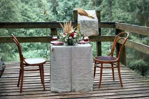 A place for a romantic date in the forest. The table is decorated with fresh  Stock Photos