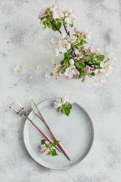 Place table setting with blossoming apple tree branches and flowers Stock Photos