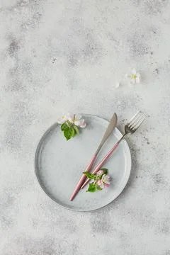 Place table setting with blossoming apple tree branches and flowers Stock Photos