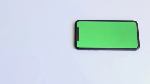 Place for tea drinking with smartphone on white table with green screen. Green Stock Footage 194009304