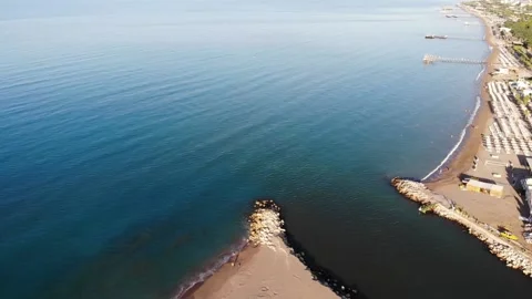 The place where the river flows into the sea and sand hotel beach in palm grove Stockbeeldmateriaal 172357546