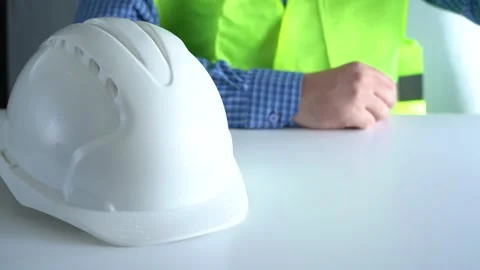 Place the white work helmet on the table. Stock Footage 166052664