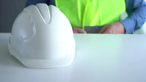 Place the white work helmet on the table. Stock Footage 166226969
