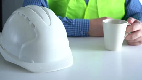 Place the white work helmet on the table. Stock Footage 166995678