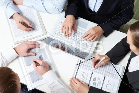 Place of work of four business people Stock Photos