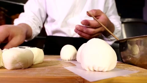 Place the wrapped bun on the cutting board Stock Footage 236550643