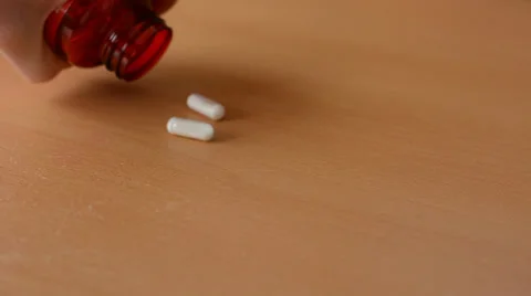 Place(put) pills on the table Stock-Footage 36984969