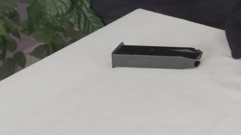 Placing .45 ACP Ammunition on Table Close Up Stock Footage 337434190