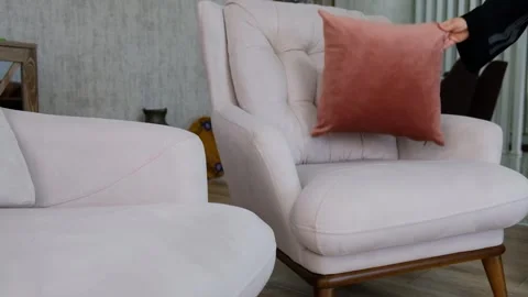 Placing and Arranging Cushions on Sofa in Cozy Living Room during Tidying Up Stock Footage 302687907
