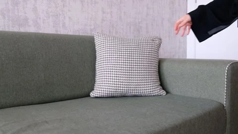 Placing and Arranging Cushions on Sofa in Cozy Living Room during Tidying Up Stock Footage 302687992