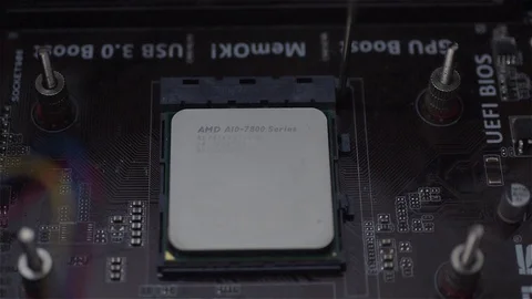 Placing and locking a computer microprocessor cpu on the motherboard slot, Stock Footage 78989181