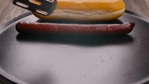 Placing Assorted Sausages on a Hot Griddle Stock Footage 314377459