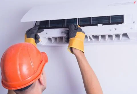 Placing back clean filter into air conditioner Stock Photos