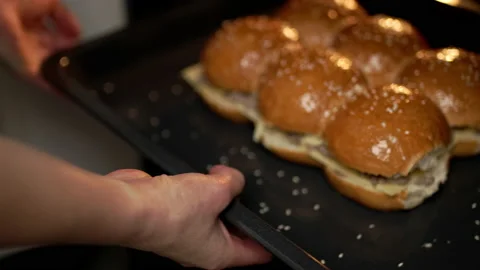 Placing beef sliders in the oven in slow motion. Stock Footage 135465172