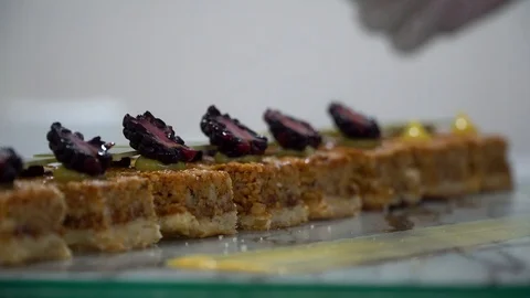 Placing black berries on cakes, dressing desserts Stock Footage 106628258