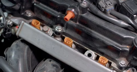 Placing the bolt on the injector rail before tightening it to secure Stock Footage 314767853