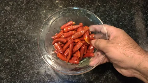 Placing a bowel of boiled red chilies in kitchen Video stock 152394615