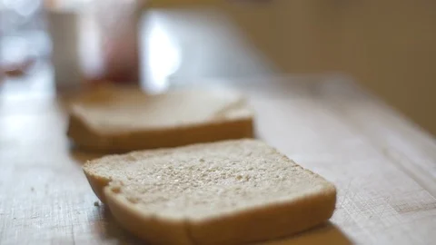 Placing Bread on Cutting Board for Sandwich Lunch Vídeo Stock 113285699