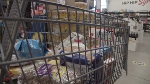 Placing bread loaf into grocery cart Stock Footage 220089285