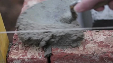 Placing a brick on a wall Stock Footage 60443104