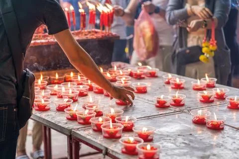 Placing candles at temple table Stock Photos