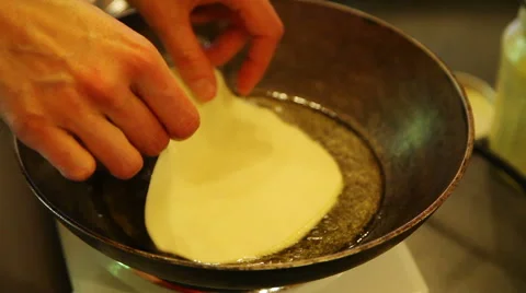Placing chapati on frying pan Stock Footage 40889526