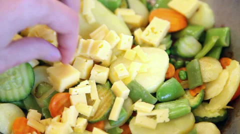 Placing cheese over vegetables Stock Footage 37528243