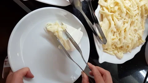 Placing cheese on a plate Stock Footage 252029340