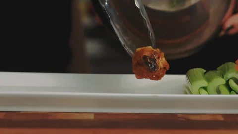 Placing Chicken Wings onto a Serving Tray Stock Footage 86161993