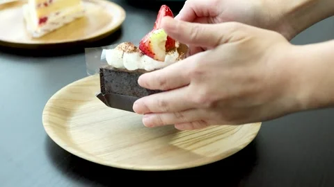 Placing Chocolate Strawberry Cake Slice on Wooden Plate Stock Footage 319003021