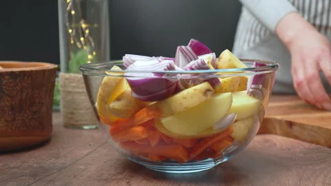 Placing chopped red onion into a transparent glass bowl in 4k. Stock Footage 145114545