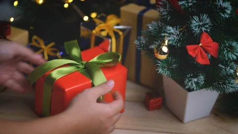 Placing Christmas Gift Besides Small Christmas Tree Stock Footage 96152386