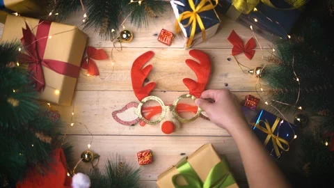 Placing Christmas Reindeer Glasses Between Christmas Gifts Ornament Stock Footage 96152192