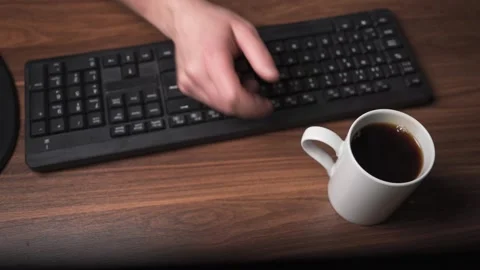 Placing coffee cup on table and starting work in office Stock Footage 335483769