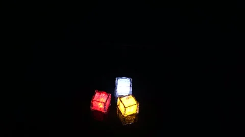 Placing Colorful LED Cubes One by One on Black Background Stock Footage 335797636