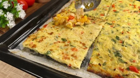 Placing cooked chicken and bell pepper filling on a baked potato crust with a sp Stock Footage 325072048