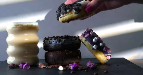 Placing Cookie Donut on Stack Beside Coffee Stock Footage 310936974