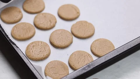 Placing Cookies On Baking Tray With Parchment Paper Stock Footage 333006693