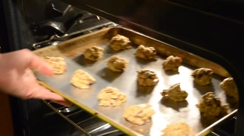 Placing Cookies in Oven Stock Footage