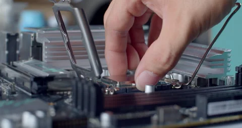 Placing the CPU into the socket aligned with the marked corner. Stock Footage 311939303