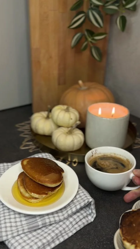 Placing a Cup of Coffee Next to Pancakes with Syrup, Cozy Autumn Scene Stock Footage 303352333