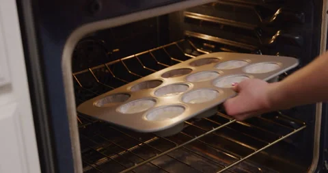 Placing cupcake tray into oven 스톡 동영상 249352808