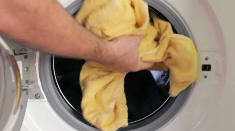 Placing dirty clothes in a washing machine Stock Footage 35196415